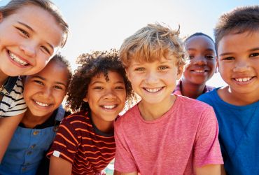 In this image, there is a child with a smiling face.