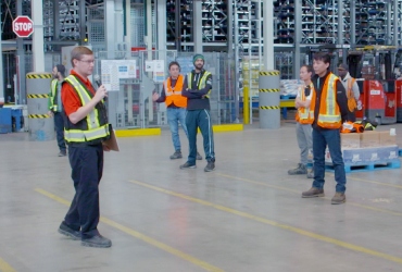 In this image, a group of people working together.